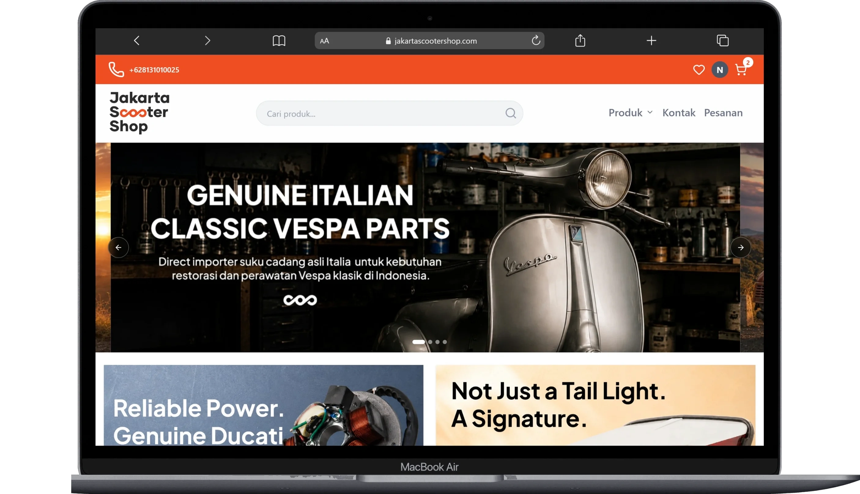 Jakarta Scooter Shop home page on MacBook Air with an orange bar, a search field, a classic Vespa banner, and product panels